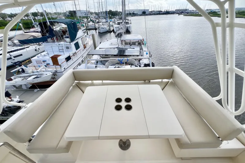 Tonga Time Yacht Photos Pics Aquila 44 yacht deck with seating and table, docked at marina, 2019 model.