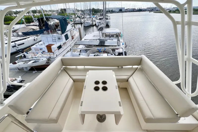 Tonga Time Yacht Photos Pics Aquila 44 yacht's seating area with table, docked at marina, 2019 model.