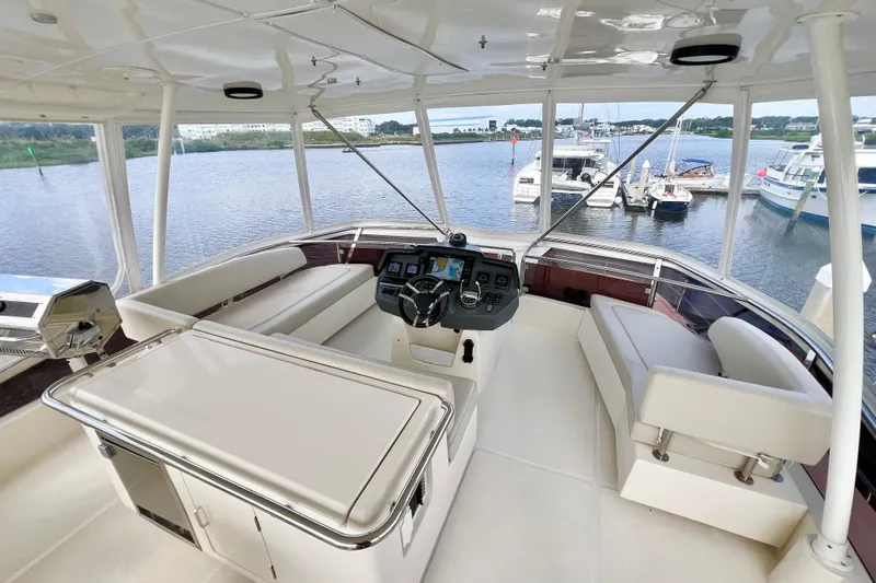 Tonga Time Yacht Photos Pics Luxurious 2019 Aquila 44 yacht interior with helm, seating, and marina view.