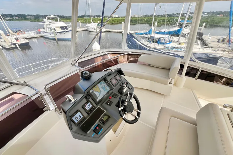 Tonga Time Yacht Photos Pics Cockpit of 2019 Aquila 44 yacht with modern navigation system and marina view.