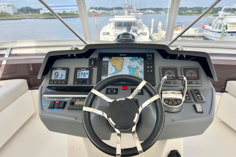 Tonga Time Yacht Photos Pics Cockpit of 2019 Aquila 44 yacht with navigation controls and display screens.