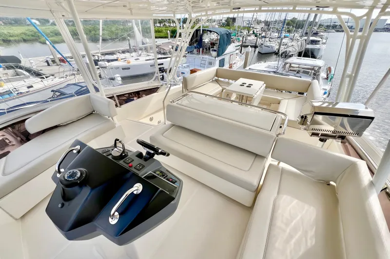 Tonga Time Yacht Photos Pics Luxurious 2019 Aquila 44 yacht interior with helm, seating, and marina view.