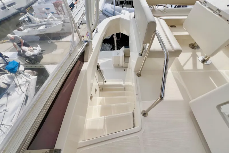 Tonga Time Yacht Photos Pics 2019 Aquila 44 yacht interior with stairs and seating area.