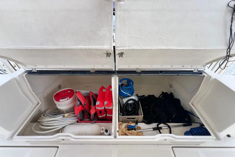 Tonga Time Yacht Photos Pics Storage compartment on a 2019 Aquila 44 boat with life jackets and equipment.