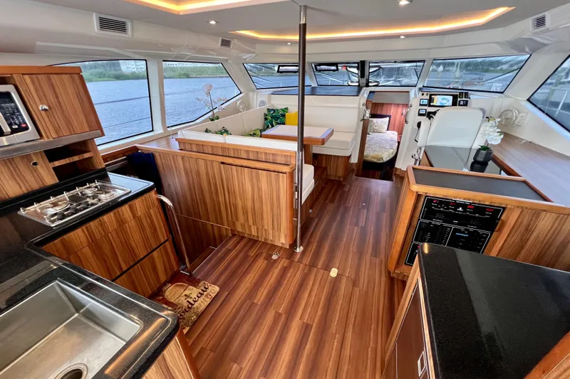 Tonga Time Yacht Photos Pics Luxurious interior of 2019 Aquila 44 yacht with modern kitchen and seating area.