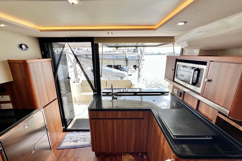 Tonga Time Yacht Photos Pics Luxurious interior of 2019 Aquila 44 yacht with modern kitchen and waterfront view.