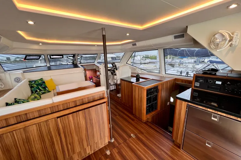 Tonga Time Yacht Photos Pics Luxurious interior of 2019 Aquila 44 yacht with modern wood finishes and plush seating.