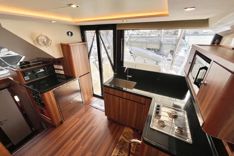 Tonga Time Yacht Photos Pics Luxurious 2019 Aquila 44 yacht kitchen with modern wood cabinetry and sleek appliances.