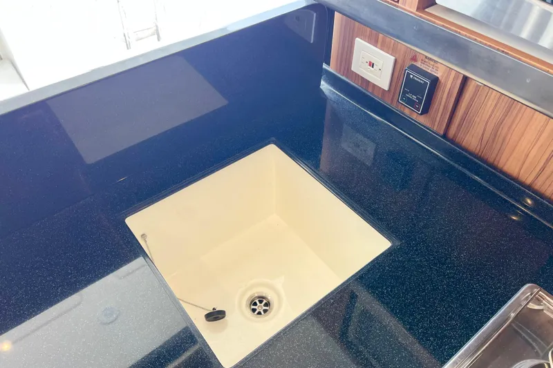 Tonga Time Yacht Photos Pics Modern kitchen sink on Aquila 44 yacht, 2019 model, with sleek countertop design.