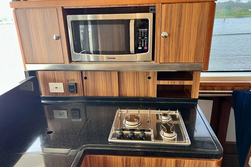 Tonga Time Yacht Photos Pics Modern kitchen in 2019 Aquila 44 yacht with microwave and stovetop.