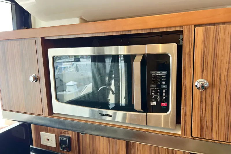 Tonga Time Yacht Photos Pics Built-in Toshiba microwave in 2019 Aquila 44 yacht kitchen cabinetry.