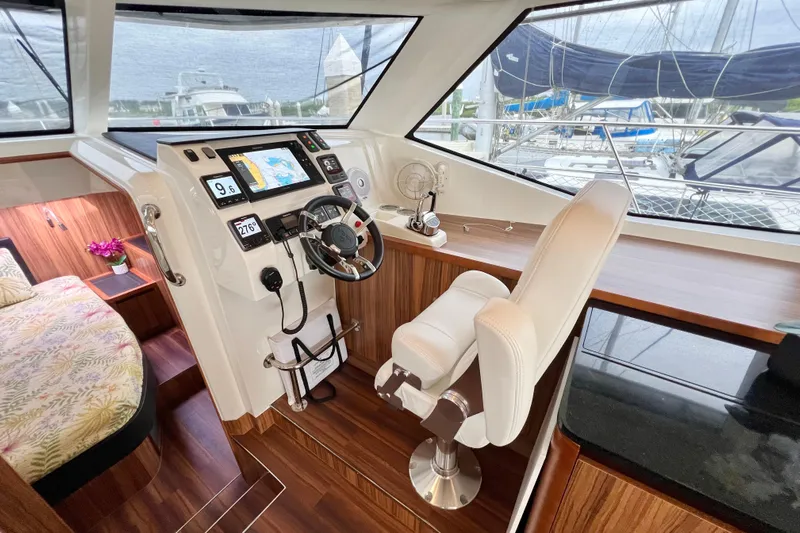 Tonga Time Yacht Photos Pics Helm station of 2019 Aquila 44 yacht with modern navigation equipment and luxurious seating.