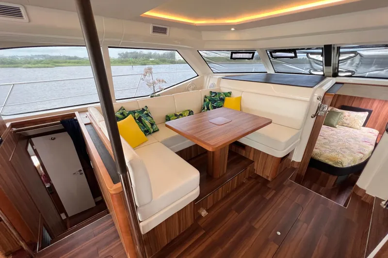 Tonga Time Yacht Photos Pics Luxurious interior of 2019 Aquila 44 yacht with elegant seating and wooden finishes.