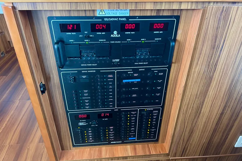 Tonga Time Yacht Photos Pics Electrical control panel on a 2019 Aquila 44 yacht, featuring voltage and amperage displays.