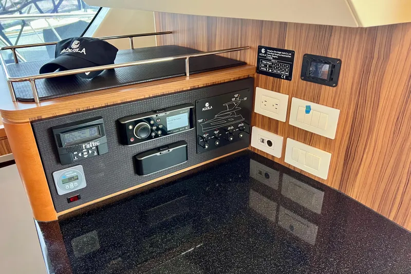 Tonga Time Yacht Photos Pics Control panel of 2019 Aquila 44 yacht with electronic devices and switches.