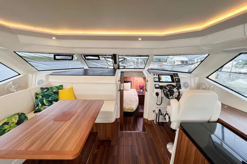 Tonga Time Yacht Photos Pics Luxurious 2019 Aquila 44 yacht interior with modern helm, seating, and elegant wood finishes.
