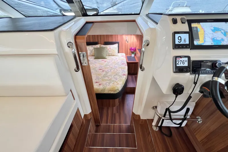 Tonga Time Yacht Photos Pics Interior of 2019 Aquila 44 yacht with modern helm and cozy cabin.