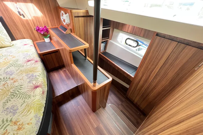 Tonga Time Yacht Photos Pics Interior of 2019 Aquila 44 yacht with wooden finish and floral bedding.