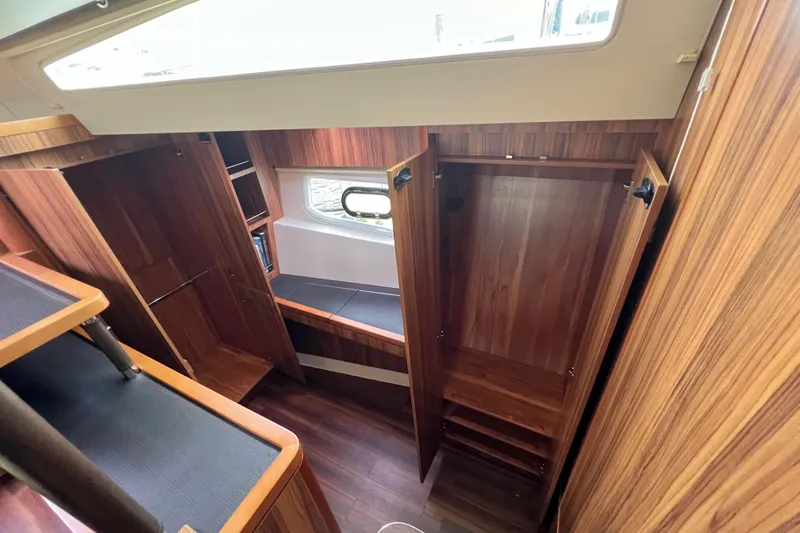 Tonga Time Yacht Photos Pics Interior of 2019 Aquila 44 yacht with wooden cabinetry and seating area.
