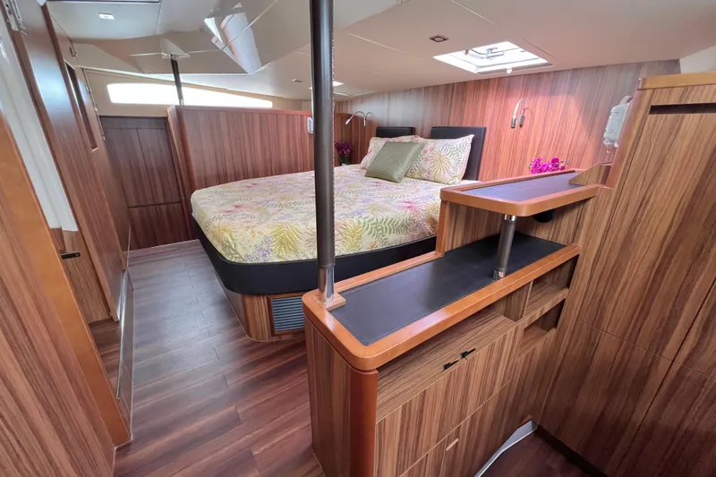 Tonga Time Yacht Photos Pics Luxurious 2019 Aquila 44 yacht cabin with wood finish and floral bedding.