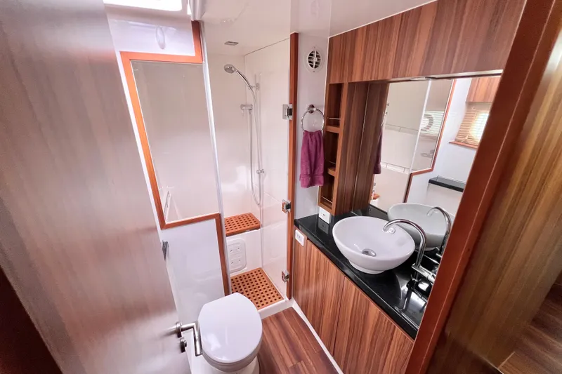 Tonga Time Yacht Photos Pics Luxurious 2019 Aquila 44 yacht bathroom with modern fixtures and wood accents.