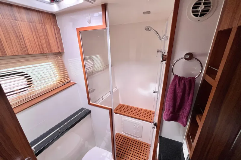 Tonga Time Yacht Photos Pics Luxurious bathroom in 2019 Aquila 44 yacht with wooden accents and modern fixtures.