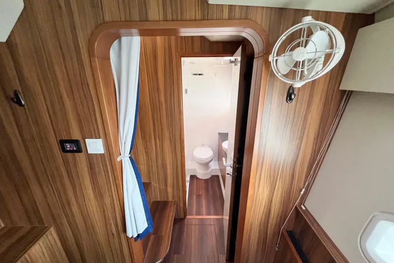 Tonga Time Yacht Photos Pics Interior of 2019 Aquila 44 yacht showing bathroom and wooden paneling.