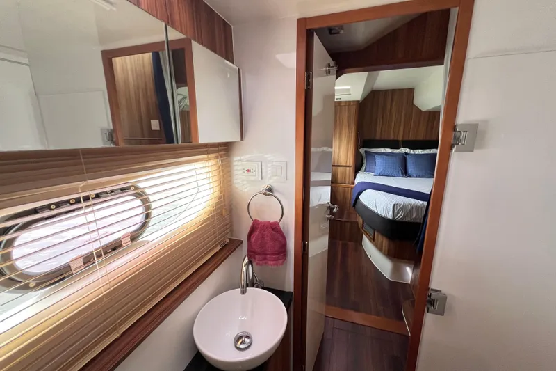 Tonga Time Yacht Photos Pics Luxurious interior of 2019 Aquila 44 yacht featuring a bedroom and bathroom.