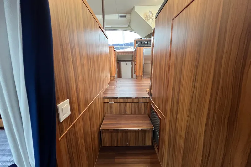 Tonga Time Yacht Photos Pics Interior of 2019 Aquila 44 yacht with wooden paneling and steps.