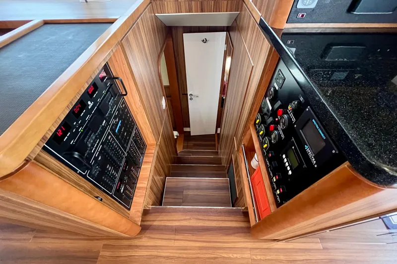 Tonga Time Yacht Photos Pics Staircase in 2019 Aquila 44 yacht with control panels and wood finish.
