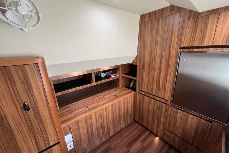 Tonga Time Yacht Photos Pics Modern wooden interior of 2019 Aquila 44 yacht with sleek cabinetry and stainless steel accents.