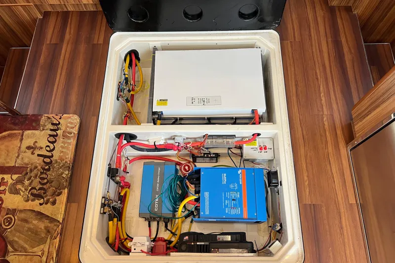 Tonga Time Yacht Photos Pics Electrical system of a 2019 Aquila 44 yacht, featuring battery chargers and wiring.