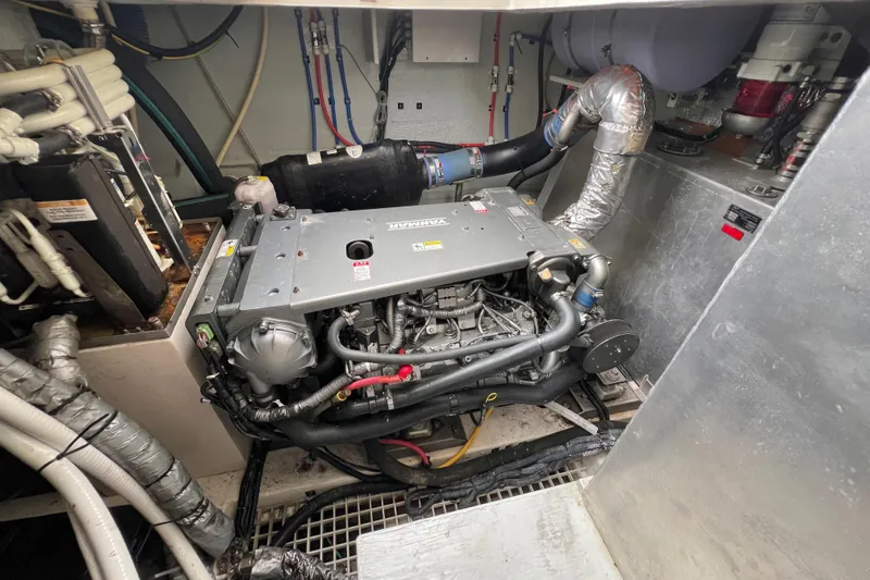 Tonga Time Yacht Photos Pics Engine room of a 2019 Aquila 44 yacht, showcasing mechanical components and piping.