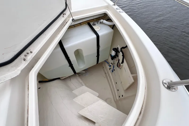 Tonga Time Yacht Photos Pics Open storage compartment on 2019 Aquila 44 boat, showing water tank and fittings.