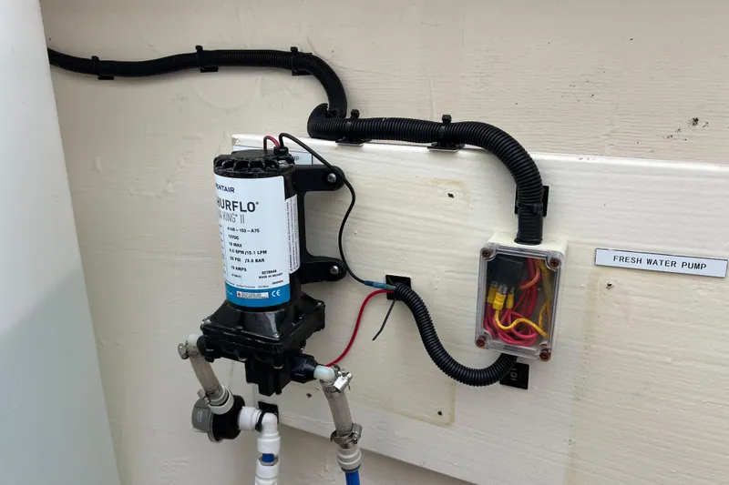 Tonga Time Yacht Photos Pics Fresh water pump system on 2019 Aquila 44 boat, featuring wiring and labeled components.