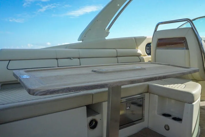  Yacht Photos Pics 2019 Chris-Craft Launch 35 GT OB interior with elegant seating and wooden table.