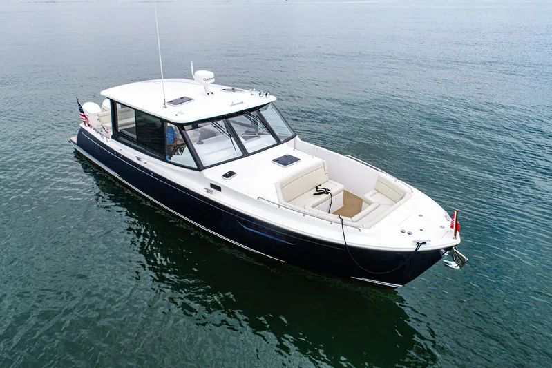 4794tw Yacht Photos Pics 2024 MJM 4 boat on calm water, featuring sleek design and spacious seating.