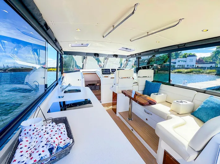4794tw Yacht Photos Pics Luxurious 2024 MJM 4 yacht interior with elegant seating and scenic water views.