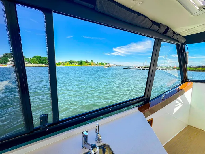 4794tw Yacht Photos Pics View from 2024 MJM 4 boat interior, overlooking serene waters and blue sky.