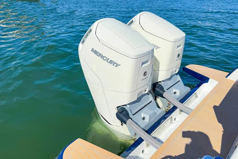 4794tw Yacht Photos Pics Twin Mercury outboard engines on a 2024 MJM 4 boat in clear blue water.