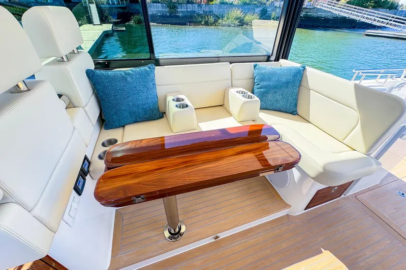 4794tw Yacht Photos Pics Luxurious 2024 MJM 4 yacht interior with elegant seating and wooden table.