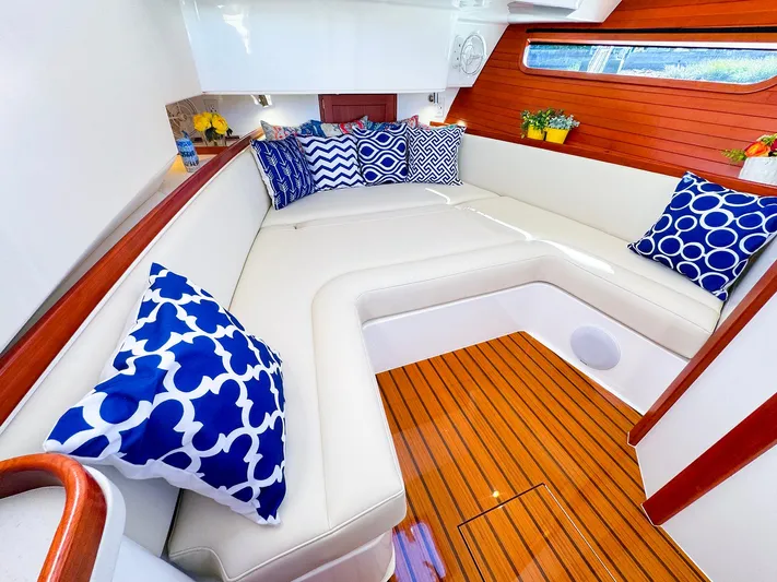 4794tw Yacht Photos Pics Luxurious 2024 MJM 4 yacht interior with elegant seating and vibrant blue-patterned cushions.