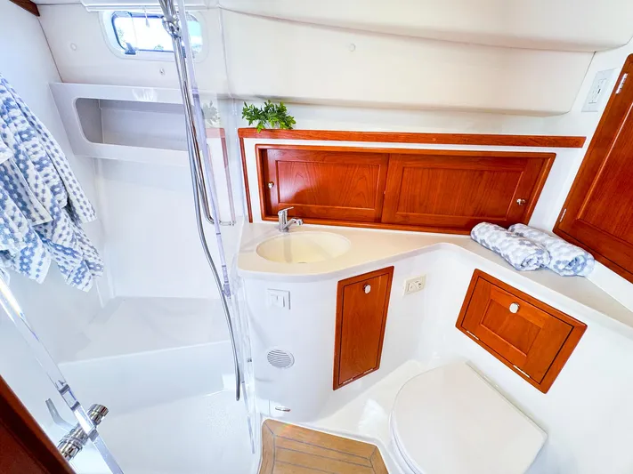 4794tw Yacht Photos Pics Luxurious bathroom in 2024 MJM 4 yacht with wooden cabinets and modern fixtures.