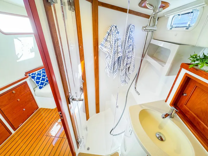 4794tw Yacht Photos Pics Luxurious 2024 MJM 4 yacht bathroom with wooden accents and modern fixtures.