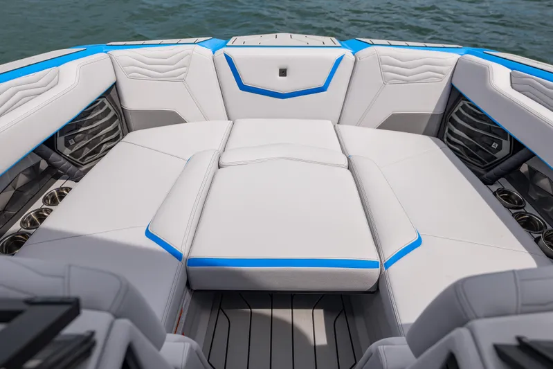  Yacht Photos Pics 2026 Nautique Super Air Nautique G23 boat interior with sleek white and blue seating.
