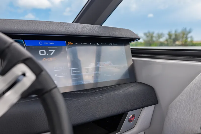  Yacht Photos Pics 2026 Nautique Super Air Nautique G23 dashboard with digital display and steering wheel.