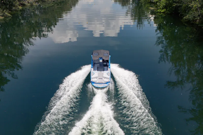  Yacht Photos Pics 2026 Nautique Super Air Nautique G23 cruising on a serene lake.