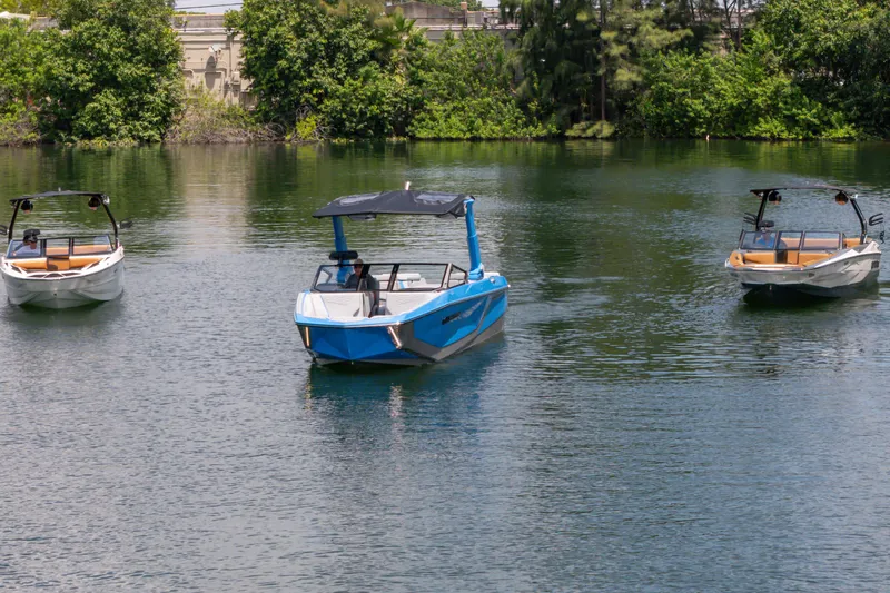  Yacht Photos Pics 2026 Nautique Super Air Nautique G23 boats on a serene lake.