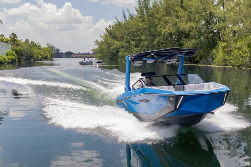  Yacht Photos Pics 2026 Nautique Super Air Nautique G23 cruising on a scenic waterway.