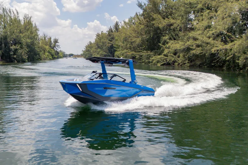  Yacht Photos Pics 2026 Nautique Super Air Nautique G23 boat cruising on a scenic waterway.